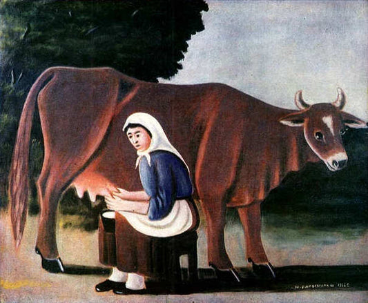 A Woman Milking A Cow